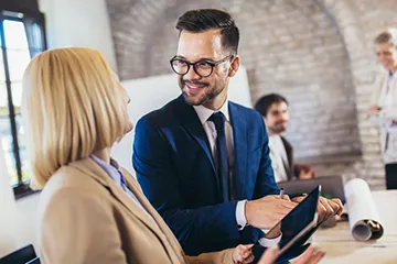 Business professionals in formal attire having a discussion